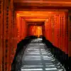 A pathway through rows of vermilion torii gates at Fushimi Inari Shrine in Kyoto.