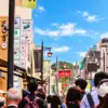 Visitors walking between shops and restaurants on Komachi Street in Kamakura.