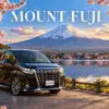 Mount Fuji tour artwork with a black Toyota Alphard beside Lake Kawaguchi and cherry blossoms.