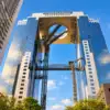Looking up at the twin towers and elevated circular observation structure of Umeda Sky Building in Osaka.