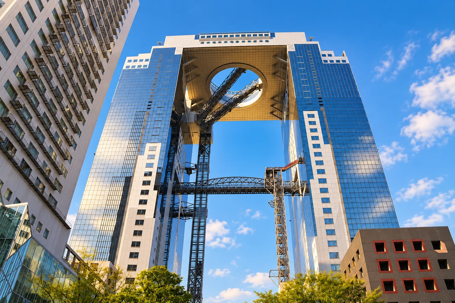 Looking up at the twin towers and elevated circular observation structure of Umeda Sky Building in Osaka.